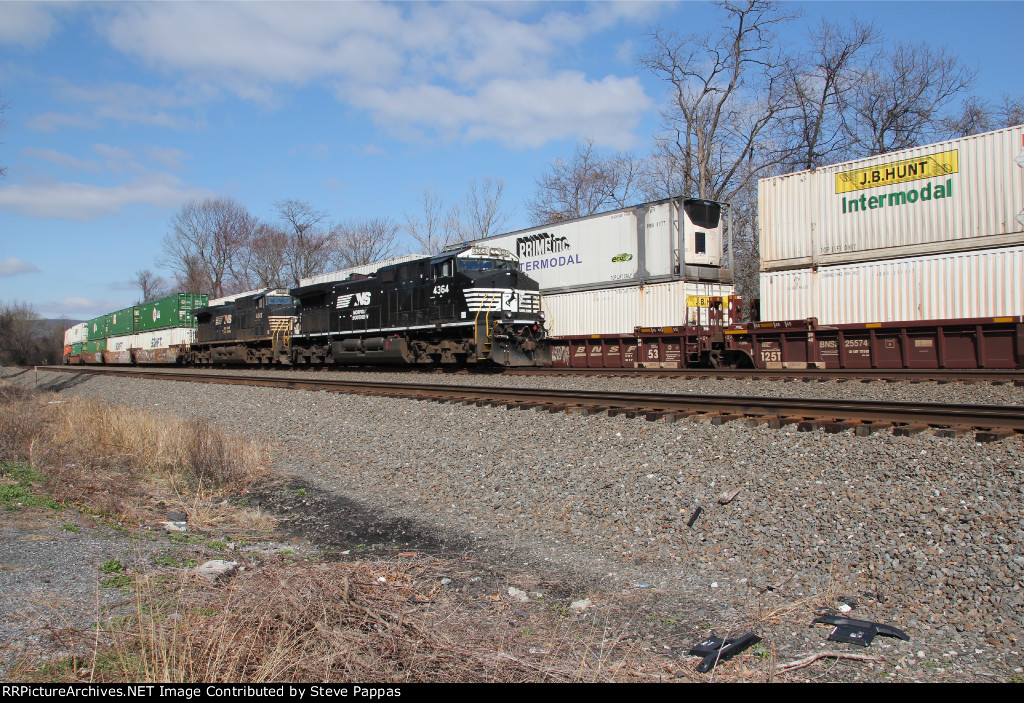NS 4364 and 4447 take a stack train east
